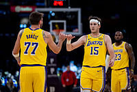 | Photo: AP/Ethan Swope : Los Angeles Lakers guard Luka Doncic (77) and Los Angeles Lakers guard Austin Reaves (15) celebrate during the second half of an NBA basketball game in Los Angeles. 