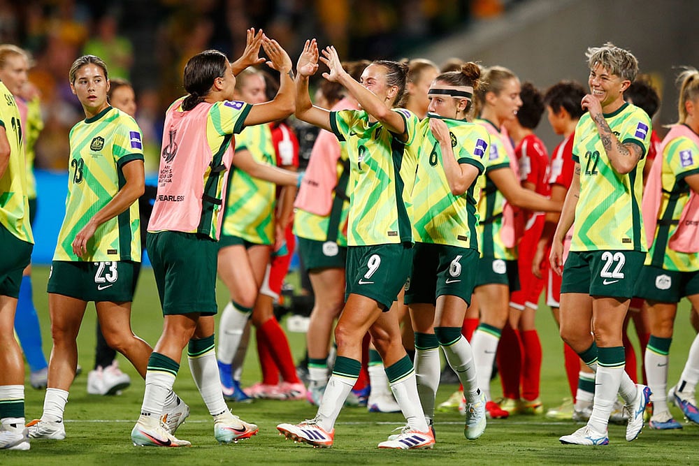 Australia's Sam Kerr and teammate Australia's Caitlin Foord celebrate following the Women's Asian Cup quarterfinal soccer match between Australia and North Korea in Perth, Australia. - | Photo: AP/Gary Day
