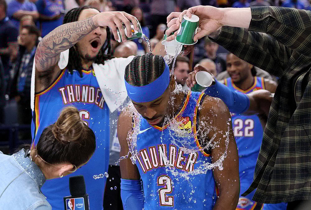 Oklahoma City Thunder forward Jaylin Williams, left, and other Thunder players pour water on Thunder guard Shai Gilgeous-Alexander (2) after an NBA basketball game against the Boston Celtics in Oklahoma City.  - | Photo: AP/Nate Billings