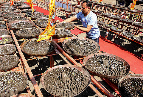 A man participates in a religious event organised to make 1.25 crore clay model Shivlingas and a recital of the 'Srimad Bhagwat Katha' under the leadership of spiritual leader Anil Prabhakar Shastrit, in Bhopal.