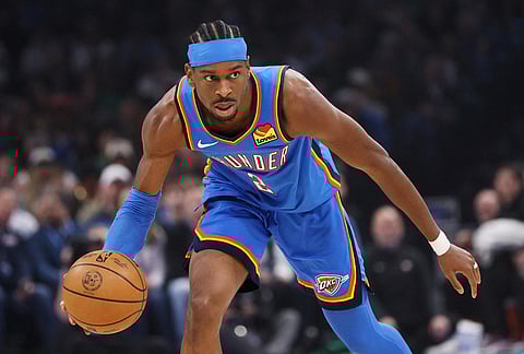 Oklahoma City Thunder guard Shai Gilgeous-Alexander handles the ball during the first half of an NBA basketball game against the Boston Celtics, in Oklahoma City. 
