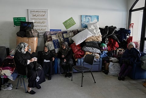 Displaced people fleeing Israeli airstrikes in southern Lebanon and Dahiyeh, Beirut's southern suburbs, settle at the Bir Hassan Technical Institute, which has been turned into a shelter, in Beirut, Lebanon, Wednesday, March 11, 2026. 