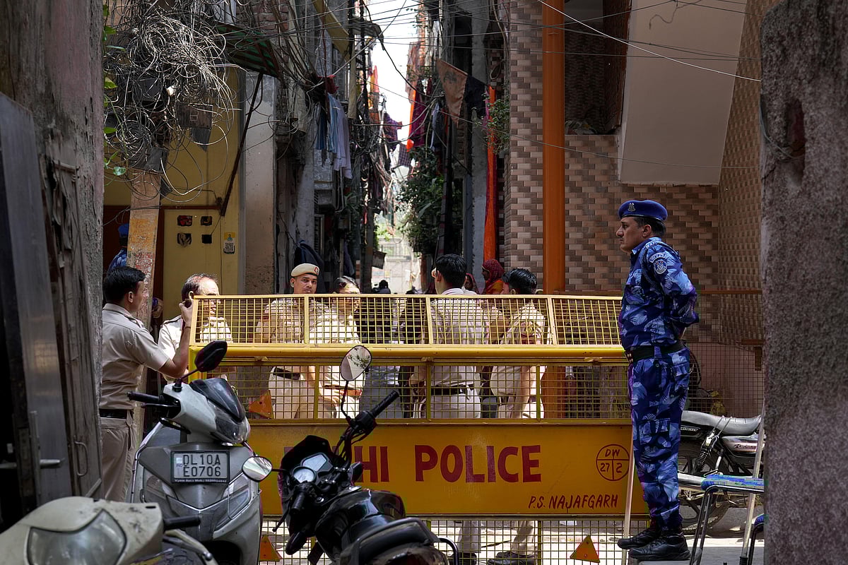 Police and CRPF personnel manning the barricades surrounding the houses of Tarun Kumar and the accused. - SURESH K PANDEY