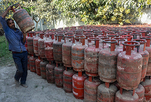 A worker arranges LPG cylinders at a gas agency, amid ongoing supply crisis in the country, in Mirzapur, Uttar Pradesh.