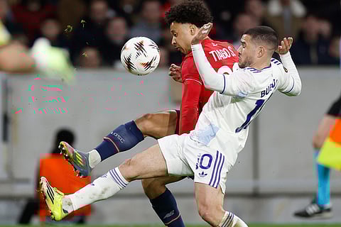 Lille's Tiago Santos, left, and Aston Villa's Emiliano Buendia fight for the ball during a first leg, round of 16 Europa League soccer match between Lille and Aston Villa in Lille, France.