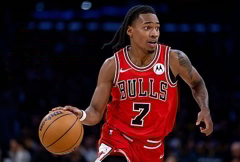 Chicago Bulls guard Rob Dillingham dribbles the ball against the Los Angeles Lakers during the second half of an NBA basketball game in Los Angeles.