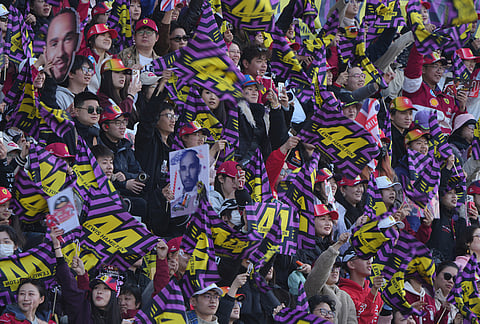 Fans cheer during the qualifying session of the Chinese Formula One Grand Prix at the Shanghai International Circuit, in Shanghai, China.