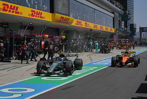 Mercedes driver Andrea Kimi Antonelli, left, of Italy and McLaren driver Oscar Piastri of Australia out of the pits during the Sprint Race of the Chinese Formula One Grand Prix at the Shanghai International Circuit, in Shanghai, China.