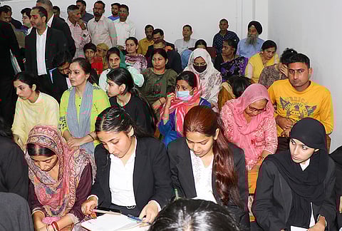People arrive at a court to file cases during the 'National Lok Adalat', in Jammu.
