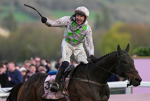 Paul Townend jockey of Gaelic Warrior the winner of the Gold Cup race, celebrates as he rides past the winning post on day four of the 2026 Cheltenham Festival in Cheltenham, England.