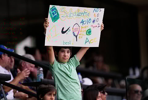 A fan holds up a sign for Aryna Sabalenka, of Belarus, during Sabalenka's semifinal match against Linda Noskova, of the Czech Republic, at the BNP Paribas Open tennis tournament in Indian Wells, California.