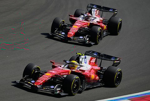 Ferrari driver Lewis Hamilton, left, of Britain races against teammate Charles Leclerc of Monaco during the Sprint Race of the Chinese Formula One Grand Prix at the Shanghai International Circuit, in Shanghai, China.