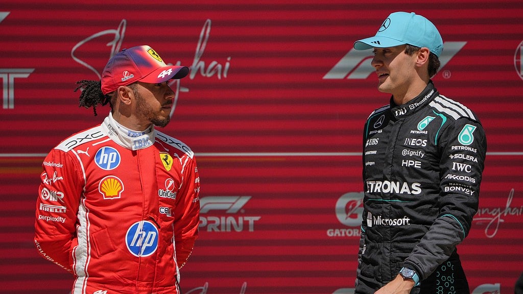 Winner Mercedes driver George Russell, right, of Britain talks with third placer Ferrari driver Lewis Hamilton of Britain after the Sprint Race of the Chinese Formula One Grand Prix at the Shanghai International Circuit, in Shanghai, China, Saturday, March 14, 2026. - AP Photo/Andy Wong
