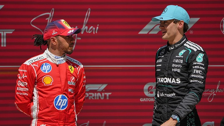 Winner Mercedes driver George Russell, right, of Britain talks with third placer Ferrari driver Lewis Hamilton of Britain after the Sprint Race of the Chinese Formula One Grand Prix at the Shanghai International Circuit, in Shanghai, China, Saturday, March 14, 2026. - AP Photo/Andy Wong