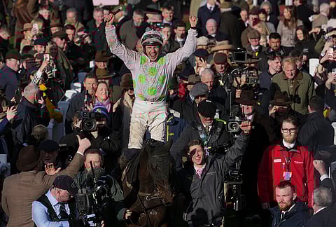 Paul Townend jockey of Gaelic Warrior the winner of the Gold Cup race, celebrates as they enter the winners enclosure on day four of the 2026 Cheltenham Festival in Cheltenham, England.