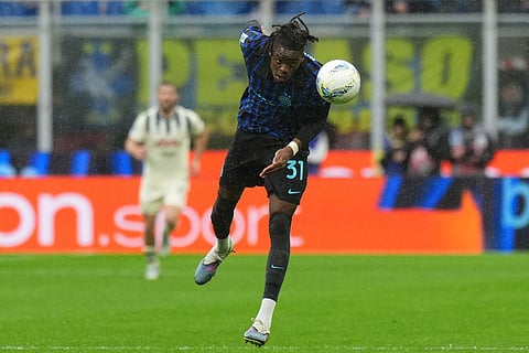 Inter Milan's Yann Bisseck heads the ball during the Serie A soccer match between Inter Milan and Atalanta in Milan, Italy.