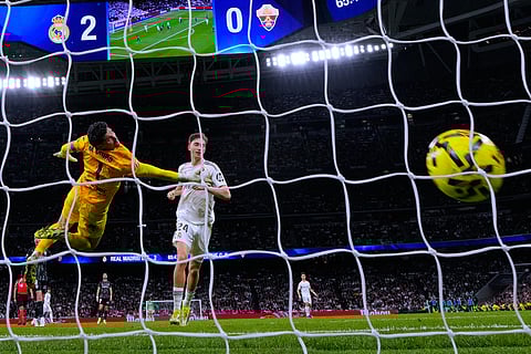 Real Madrid's Dean Huijsen scores his side's third goal during a Spanish La Liga soccer match between Real Madrid and Elche CF, in Madrid.