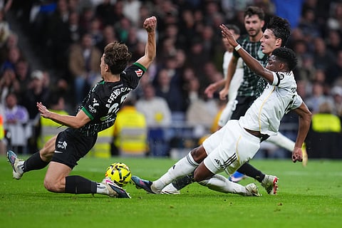 Real Madrid's Aurelien Tchouameni, right, is challenged by Elche's David Affengruber during a Spanish La Liga soccer match between Real Madrid and Elche CF, in Madrid.