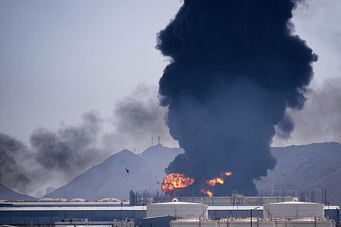 A fire and plume of smoke rise after, according to authorities. debris from an intercepted Iranian drone struck an oil facility in Fujairah, United Arab Emirates.