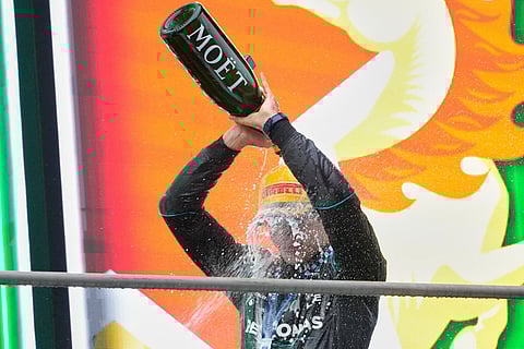 Race winner Mercedes driver Andrea Kimi Antonelli of Italy pours champagne on himself as he celebrates on the podium after the Chinese Formula One Grand Prix at the Shanghai International Circuit in Shanghai, China.