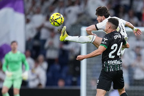 Elche's Lucas Cepeda and Real Madrid's Fran Garcia, rear, vie for the ball during a Spanish La Liga soccer match between Real Madrid and Elche CF, in Madrid.