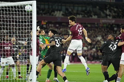 West Ham's Konstantinos Mavropanos (15) scores his side's first goal during the English Premier League soccer match between West Ham United and Manchester City in London, England.