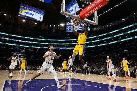 Los Angeles Lakers center Deandre Ayton (5) dunks during the second half of an NBA basketball game against the Denver Nuggets in Los Angeles.
