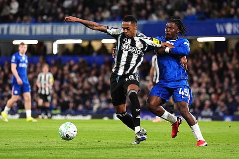Newcastle United's Joe Willock, left, and Chelsea's Romeo Lavia battle for the ball during the Premier League match between Chelsea and Newcastle, in London.