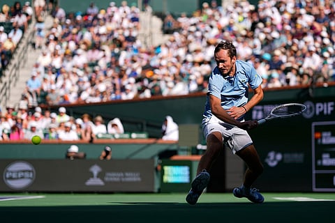 Daniil Medvedev, of Russia, returns a shot against Carlos Alcaraz, of Spain, during a semifinal match at the BNP Paribas Open tennis tournament in Indian Wells, Calif.