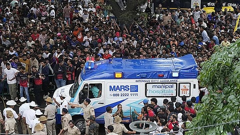 An ambulance arrives at the M. Chinnaswamy Stadium as fans gather to celebrate Royal Challengers Bengaluru cricketers, winners of the Indian Premier League 2025, in Bengaluru.