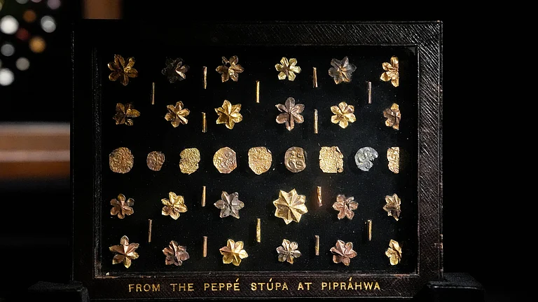 A few of the relics that were taken out of the country by Peppe and repatriated in 2025.
In 1898, William Claxton Peppé discovered the Piprahwa gem relics, which led to 349 gem relics being placed under his custody. A significant portion of these relics became part of the Imperial Museum in Calcutta, now known as the Indian Museum in Kolkata. The museum classified these relics as ‘AA’ antiquities, which prohibited their sale and restricted their movement. However, they are now displayed in this magnificent exhibition for the first time and reunited with the repatriated gem relics which were once taken away from India by the Peppé family. These gems, made from semiprecious stones, pearls, and beads, are shaped into emblems such as the tri-ratna, bird, leaf, and lotus motifs. Alongside these gems are numerous pieces of gold and silver leaf, some of which are impressed with crosses, lions, and early Buddhist symbols. Among the unique pieces is a group of tiny ornaments referred to as “star-shaped flowers” by Harry Falk. These jewels were carved from small, flat stone cones, hollowed at the centre and shaped into six or more petals by meticulously sawing the stone between them. This process required great skill and precision. Each ornament has a central perforation, indicating that they were initially strung, possibly as part of a necklace, garland, or decorative textile. A faint circular mark where the petals meet suggests that they were shaped using a thread saw, a delicate ancient tool. - Photo: Vikram Sharma