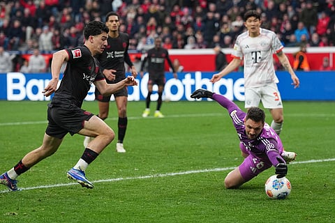 Bayern's goalkeeper Sven Ulreich makes a save against Leverkusen's Ibrahim Maza, left, during a German Bundesliga soccer match between Bayer Leverkusen and Bayern Munich in Leverkusen, Germany.