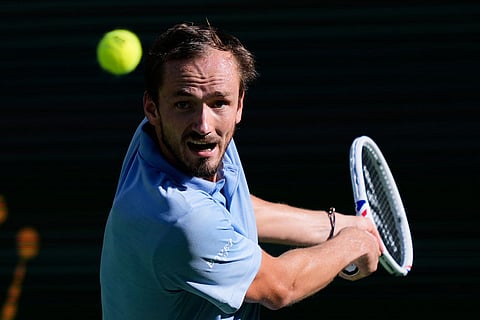 Daniil Medvedev, of Russia, returns a shot against Carlos Alcaraz, of Spain, during a semifinal match at the BNP Paribas Open tennis tournament in Indian Wells, Calif.