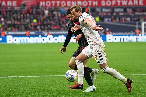 Bayern's Harry Kane, right, challenges for the ball with Leverkusen's Equi Fernandez during a German Bundesliga soccer match between Bayer Leverkusen and Bayern Munich in Leverkusen, Germany.