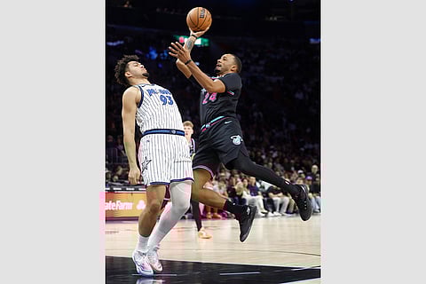 Miami Heat guard Norman Powell (24) shoots around Orlando Magic forward Noah Penda (93) during the second half of an NBA basketball game in Miami.