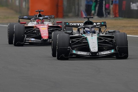 Mercedes driver George Russell of Britain steers his car ahed of Ferrari driver Charles Leclerc of Monaco during the Chinese Formula One Grand Prix race at the Shanghai International Circuit, in Shanghai, China.
