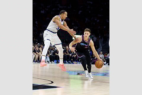 Orlando Magic guard Desmond Bane (3) defends Miami Heat guard Pelle Larsson (9) during the second half of an NBA basketball game in Miami.