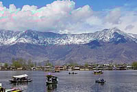 Day In Pics: March 16, 2026 | Photo: PTI : Shikaras ferry tourists on the Dal Lake with snow-clad mountains in the backdrop, in Srinagar.