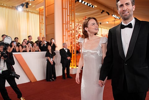 Emma Stone, left, and Dave McCary arrive at the Oscars at the Dolby Theatre in Los Angeles. 