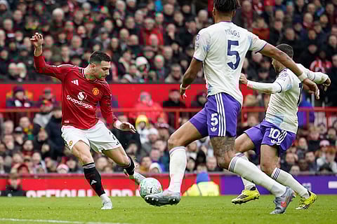 Manchester United's Diogo Dalot shoots during the Premiier League soccer match between Manchester United and Aston Villa in Manchester, England.