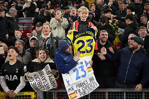 Totteham fans celebrate after the Premier League soccer match between Liverpool and Tottenham in Liverpool, England.