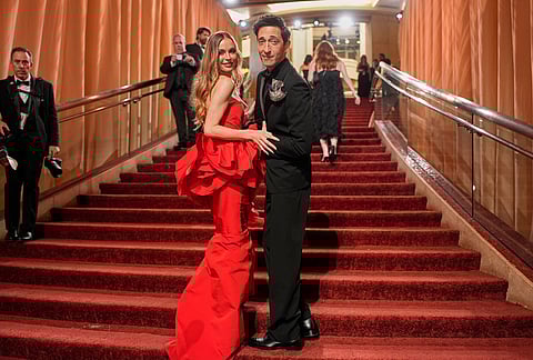 Adrien Brody, left, and Georgina Chapman arrive at the Oscars at the Dolby Theatre in Los Angeles. 