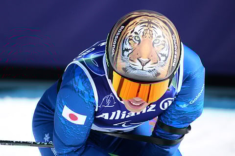 Gakuta Koike, of Japan, reacts after competing in the alpine skiing men's downhill standing competition at the 2026 Winter Paralympics, in Cortina d'Ampezzo, Italy.