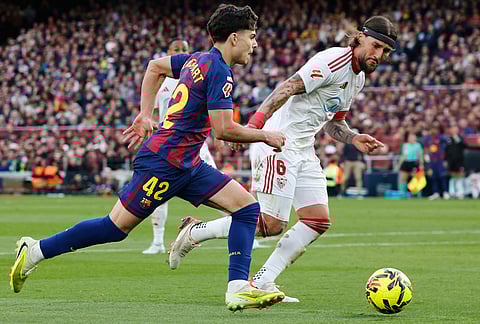 Barcelona's Xavi Espart, left, in action against Sevilla's Nemanja Gudelj during the Spanish La Liga soccer match between Barcelona and Sevilla in Barcelona, Spain.