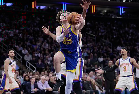 Golden State Warriors' Brandin Podziemski drives to the basket during the first half of an NBA basketball gameagainst the New York Knicks in New York.