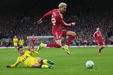 Liverpool's Hugo Ekitike escapes tackle by Tottenham's Pedro Porro during the Premier League soccer match between Liverpool and Tottenham in Liverpool, England.