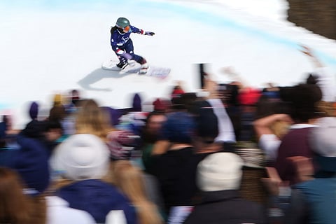 Kate Delson, of the United States, competes in her second run of the snowboard women's banked slalom sb-ll2 at the 2026 Winter Paralympics, in Cortina d'Ampezzo, Italy.
