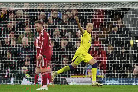 Tottenham's Richarlison celebrates after scoring during the Premier League soccer match between Liverpool and Tottenham in Liverpool, England.