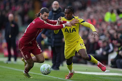Liverpool's Dominik Szoboszlai, left, and Tottenham's Mathys Tel fight for the ball during the Premier League soccer match between Liverpool and Tottenham in Liverpool, England.