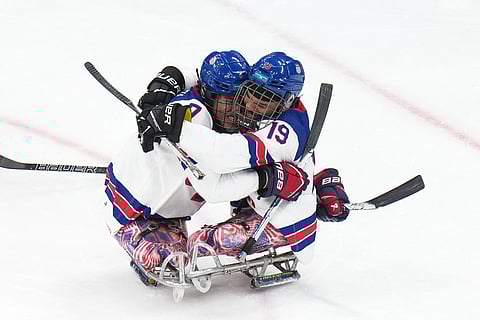 United States' Kayden Beasley, left, celebrates with his teammate Malik Jones after scoring during the ice hockey gold medal match between United States and Canada at the 2026 Winter Paralympics, in Milan, Italy.